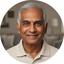 Gokulakrishnan Azalah, distinguished senior man in a polo shirt at home