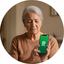 Kasee Kyle, grandmother of four, holding a smartphone showing WhatsApp